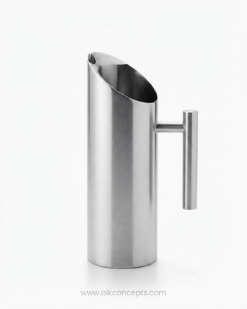 A modern stainless steel pitcher with a slanted pouring spout and a cylindrical side handle, Commercial Stainless Steel Water Pitcher, 1.5 Liter Stainless Beverage Jug, Hotel Room Service Water Jug, Catering Stainless Steel Carafe, Modern Cylinder Beverage Pitcher, Stainless Steel Pitcher with Ice Guard, Commercial Dining Room Water Pitcher, Silver Stainless Steel Serving Jug, Hotel Banquet Water Pitcher, Restaurant Metal Drink Pitcher