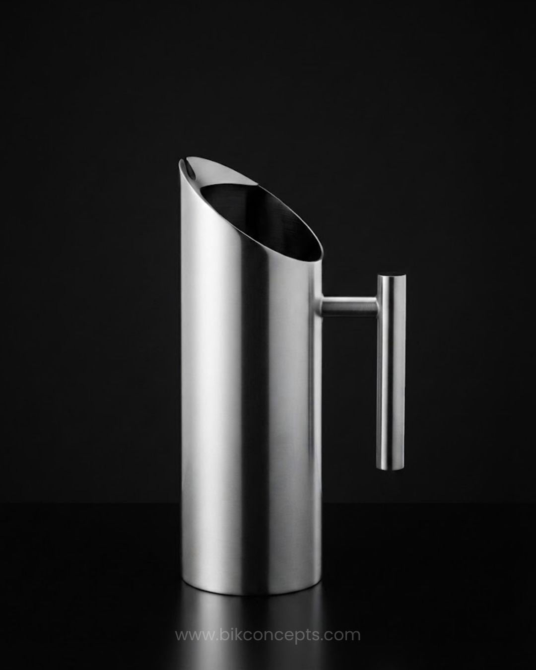 A modern stainless steel pitcher with a tapered, angled pouring spout and a vertical handle, Commercial Stainless Steel Water Pitcher, 1.5 Liter Stainless Beverage Jug, Hotel Room Service Water Jug, Catering Stainless Steel Carafe, Modern Cylinder Beverage Pitcher, Stainless Steel Pitcher with Ice Guard, Commercial Dining Room Water Pitcher, Silver Stainless Steel Serving Jug, Hotel Banquet Water Pitcher, Restaurant Metal Drink Pitcher
