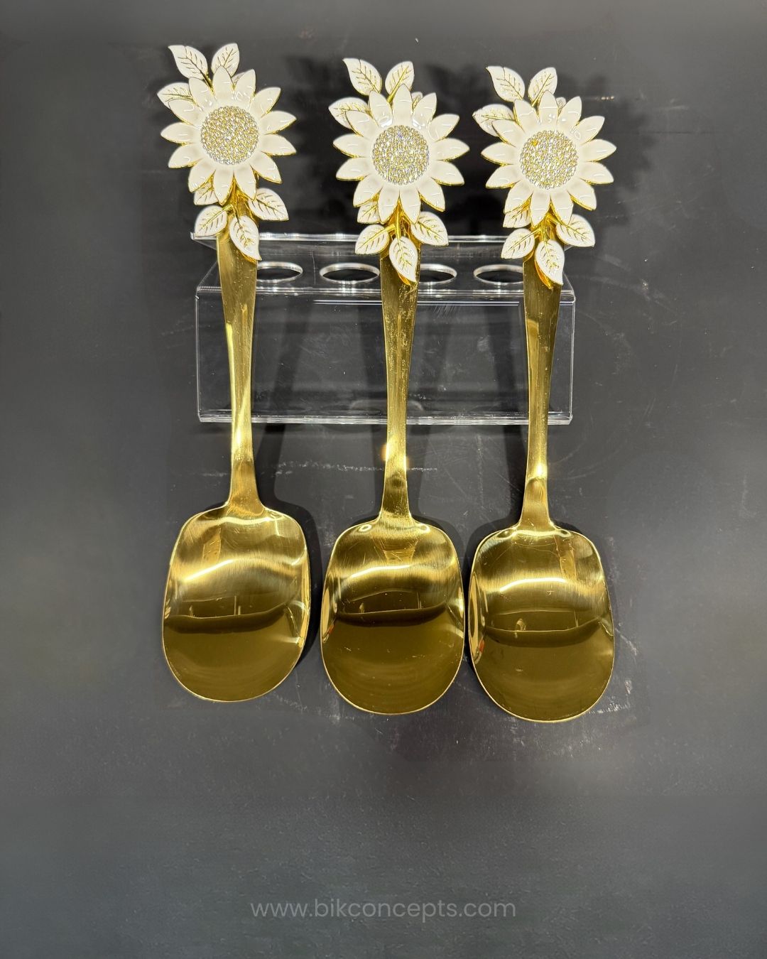 Three gold-colored spoons with white sunflower handles, Gold Stainless Steel Rice Serving Spoon, Sunflower Flat Rice Paddle, 11 Inch Flat Gold Serving Spoon, Set of 3 Gold Rice Spoons, Set of 5 Buffet Rice Paddles, Decorative Floral Handle Kitchen Utensils, Gold Biryani Serving Spoon Set, Luxury Tableware Rice Server, Decorative Flat Serving Utensils, High End Entertaining Rice Paddle