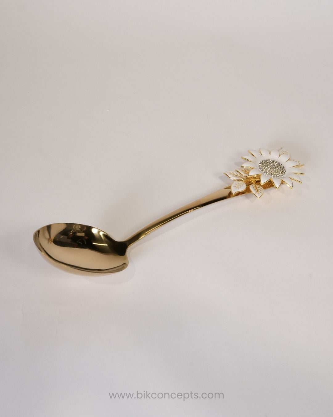 A gold-colored metal spoon with a decorative sunflower handle, Gold Stainless Steel Serving Spoon, Sunflower Decorative Serving Set, 11 Inch Round Gold Serving Spoons, Set of 3 Gold Buffet Spoons, Set of 5 Tableware Serving Spoons, Floral Enamel Handle Flatware, Luxury Gold Serving Utensils, Decorative Kitchen Serving Spoons, High End Entertaining Cutlery, Gold Rice and Curry Serving Spoon