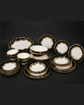 A collection of white ceramic dinnerware with ornate gold trim, including plates, bowls, and serving dishes,28 Piece Porcelain Dinnerware Set, Luxury Gold Plated Dinner Set, Black and Gold Crockery Set for 6, High End Porcelain Dish Set USA, Designer Scalloped Edge Dinnerware, Regal Baroque Gold Dinner Plates, Elegant Estate Dining Table Set, Luxury Wedding Registry Crockery, Gold Rimmed Soup Bowl Set, Fine Porcelain Oval Serving Platter