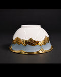 A white ceramic bowl with a light blue lower section and ornate metallic gold decorative bands, photographed against a dark studio background.28 Piece Porcelain Dinnerware Set, Luxury Gold Plated Dinner Set, Powder Blue and Gold Crockery Set for 6, High End Porcelain Dish Set USA, Designer Scalloped Edge Dinnerware, Regal Baroque Gold Dinner Plates, Elegant Estate Dining Table Set, Luxury Wedding Registry Crockery, Gold Rimmed Soup Bowl Set, Fine Porcelain Oval Serving Platter