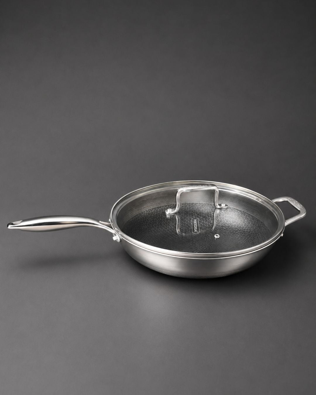 A stainless steel sauté pan with a matching glass lid featuring a metal handle, Honeycomb Stainless Steel Wok, 5.7 Quart Karahi Pan with Lid, Luxury Stainless Steel Chef Pan, Designer 12.5 Inch Stir Fry Pan USA, Non Stick Stainless Steel Wok, High End Gourmet Serving Pan, Professional Grade Hybrid Cookware, Induction Compatible Karahi Wok, Estate Kitchenware Gourmet Pans, Large Capacity Stainless Steel Wok