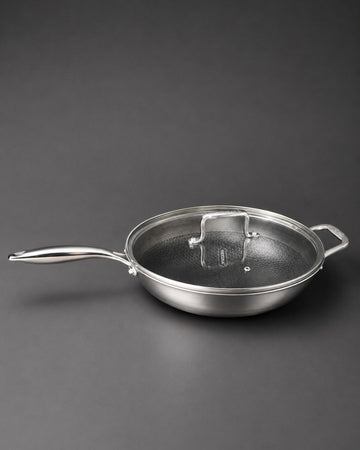 A stainless steel sauté pan with a matching glass lid featuring a metal handle, Honeycomb Stainless Steel Wok, 5.7 Quart Karahi Pan with Lid, Luxury Stainless Steel Chef Pan, Designer 12.5 Inch Stir Fry Pan USA, Non Stick Stainless Steel Wok, High End Gourmet Serving Pan, Professional Grade Hybrid Cookware, Induction Compatible Karahi Wok, Estate Kitchenware Gourmet Pans, Large Capacity Stainless Steel Wok
