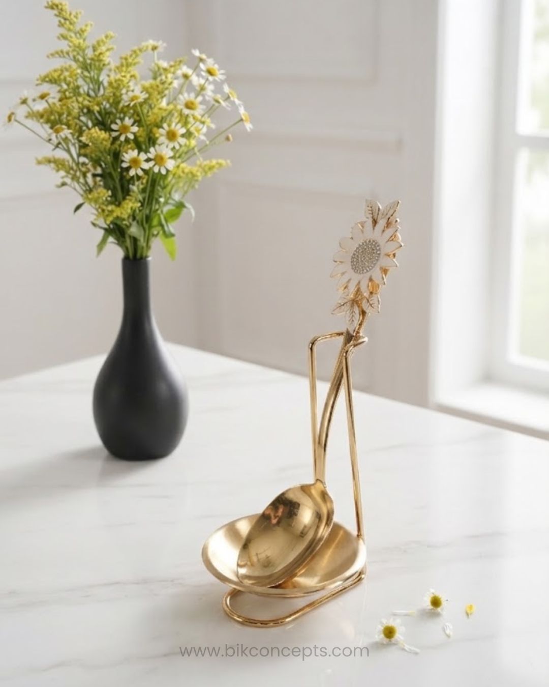 A gold metal sunflower-shaped serving stand holding two gold ladles,Gold Stainless Steel Spoon Rest, Vertical Ladle Holder Stand, Gold Utensil Rest for Buffets, Luxury Catering Tableware Accessories, Standing Spoon Holder with Drip Bowl, Brushed Gold Soup Ladle Stand, Catering Buffet Drip Tray, High End Dining Table Spoon Rest, Stainless Steel Tabletop Utensil Stand, Gold Buffet Counter Organizer