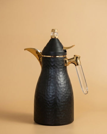 A black hammered metal coffee pot with gold-toned metal accents and a clear glass handle
Black Hammered Steel Coffee Thermos, 1 Liter Thermal Coffee Carafe, Black and Gold Vacuum Flask, Luxury Catering Coffee Dispenser, Decorative Black Tea Carafe, Dallah Style Coffee Server, Insulated Beverage Carafe for Weddings, Thermal Flask for Catering Events, High End Hot Water Thermos USA, Matte Black Vacuum Insulated Pitcher