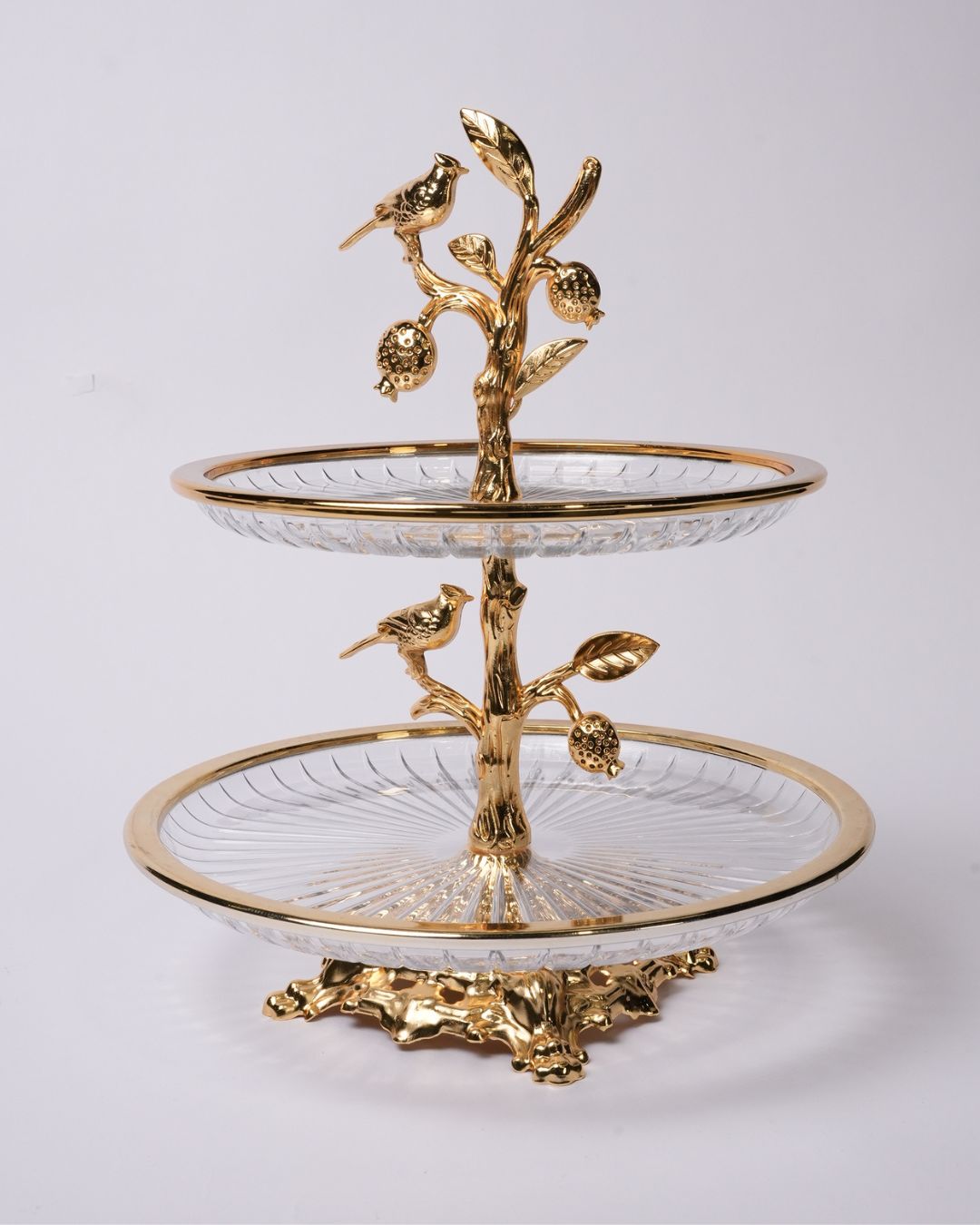 A two-tiered serving stand with clear glass plates, a gold metal base, and a central branch motif topped with two small birds and pinecones, photographed on a light gray studio background.

Gold 2 Tier Glass Serving Stand, Two Tier Round Glass Dessert Tower, Luxury Home Party Serving Tray, Botanical Bird Food Stand, Cut Glass Tiered Appetizer Tray, Gold Metal and Glass Pastry Tower, Afternoon Tea Dessert Stand, Decorative Fruit and Dessert Display, Gold Pedestal Glass Serving Tray, Elegant Tiered Buffet Ser