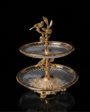 An ornate two-tiered serving stand with clear cut-glass plates and a gold-tone metal frame featuring bird and branch motifs, photographed against a black background with a reflection below.

Gold 2 Tier Glass Serving Stand, Two Tier Round Glass Dessert Tower, Luxury Home Party Serving Tray, Botanical Bird Food Stand, Cut Glass Tiered Appetizer Tray, Gold Metal and Glass Pastry Tower, Afternoon Tea Dessert Stand, Decorative Fruit and Dessert Display, Gold Pedestal Glass Serving Tray, Elegant Tiered Buffet Se