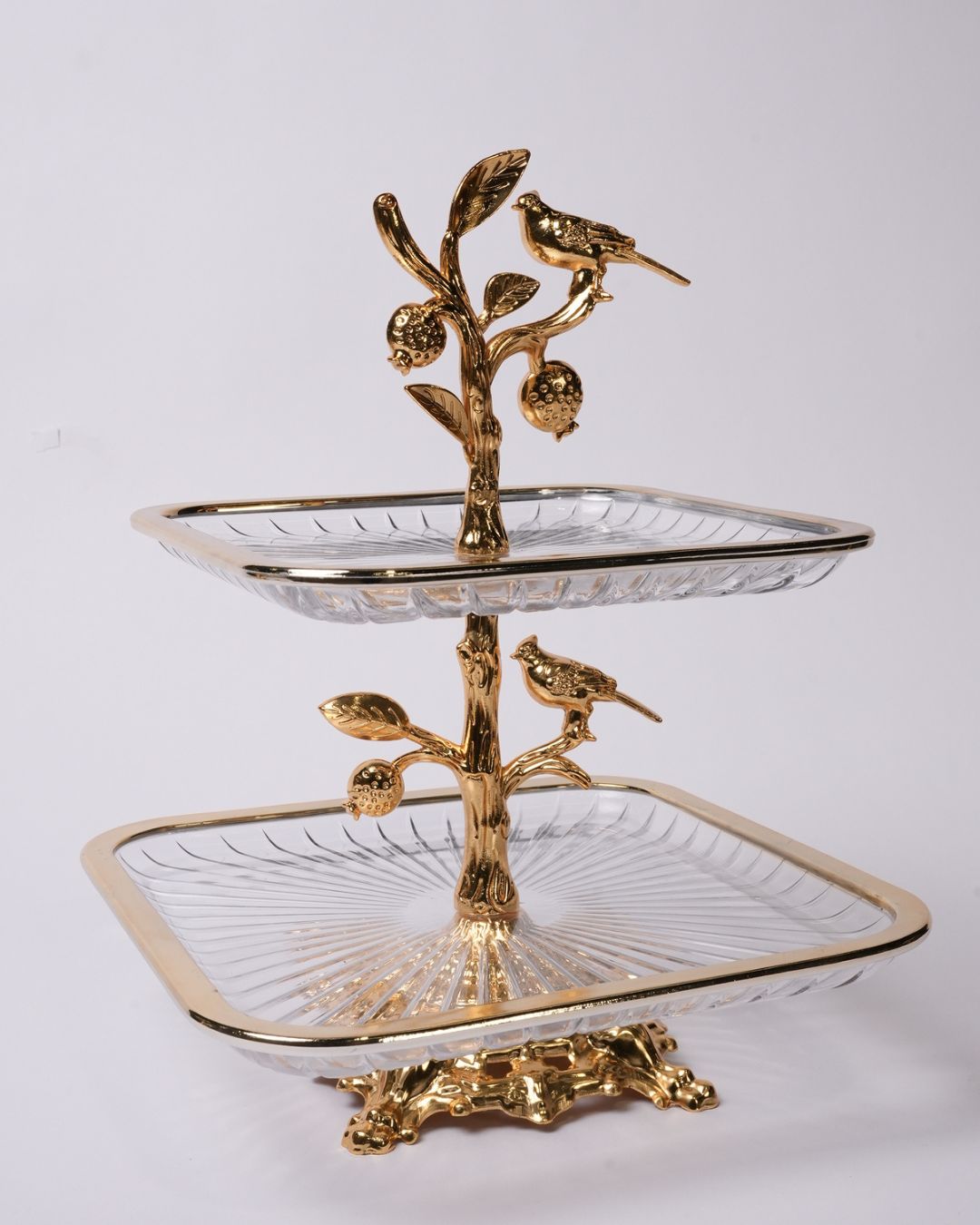 A two-tiered serving tray stand with clear ribbed glass trays and ornate gold-tone metal branches, acorns, and birds, photographed against a plain light gray background.
Gold 2 Tier Glass Serving Stand, Square Tiered Dessert Stand, Luxury Home Party Serving Tray, Botanical Bird Food Stand, Cut Glass Square Appetizer Tray, Gold Metal and Glass Pastry Tower, Afternoon Tea Dessert Display, Decorative Square Fruit and Dessert Stand, Gold Pedestal Glass Serving Platter, Elegant Square Tiered Buffet Stand