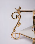 Close-up of a gold metal stand or frame with a small bird perched on a curved arm, set against a plain light background.
Gold 2 Tier Serving Stand, Two Tier Ceramic Dessert Stand, High End Catering Dessert Tray, Botanical Bird Food Stand, Rectangular Ceramic Serving Rack, Luxury Party Dessert Display, Gold Metal Tiered Pastry Stand, Upscale Wedding Dessert Tower, Designer Buffet Serving Rack, Double Layer Macaron Stand