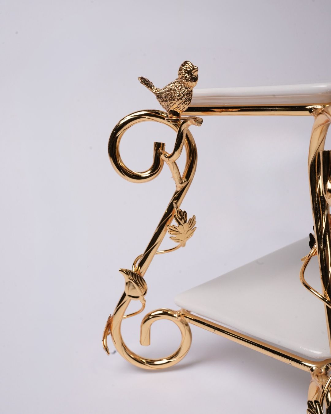 Close-up of a gold metal stand or frame with a small bird perched on a curved arm, set against a plain light background.
Gold 2 Tier Serving Stand, Two Tier Ceramic Dessert Stand, High End Catering Dessert Tray, Botanical Bird Food Stand, Rectangular Ceramic Serving Rack, Luxury Party Dessert Display, Gold Metal Tiered Pastry Stand, Upscale Wedding Dessert Tower, Designer Buffet Serving Rack, Double Layer Macaron Stand