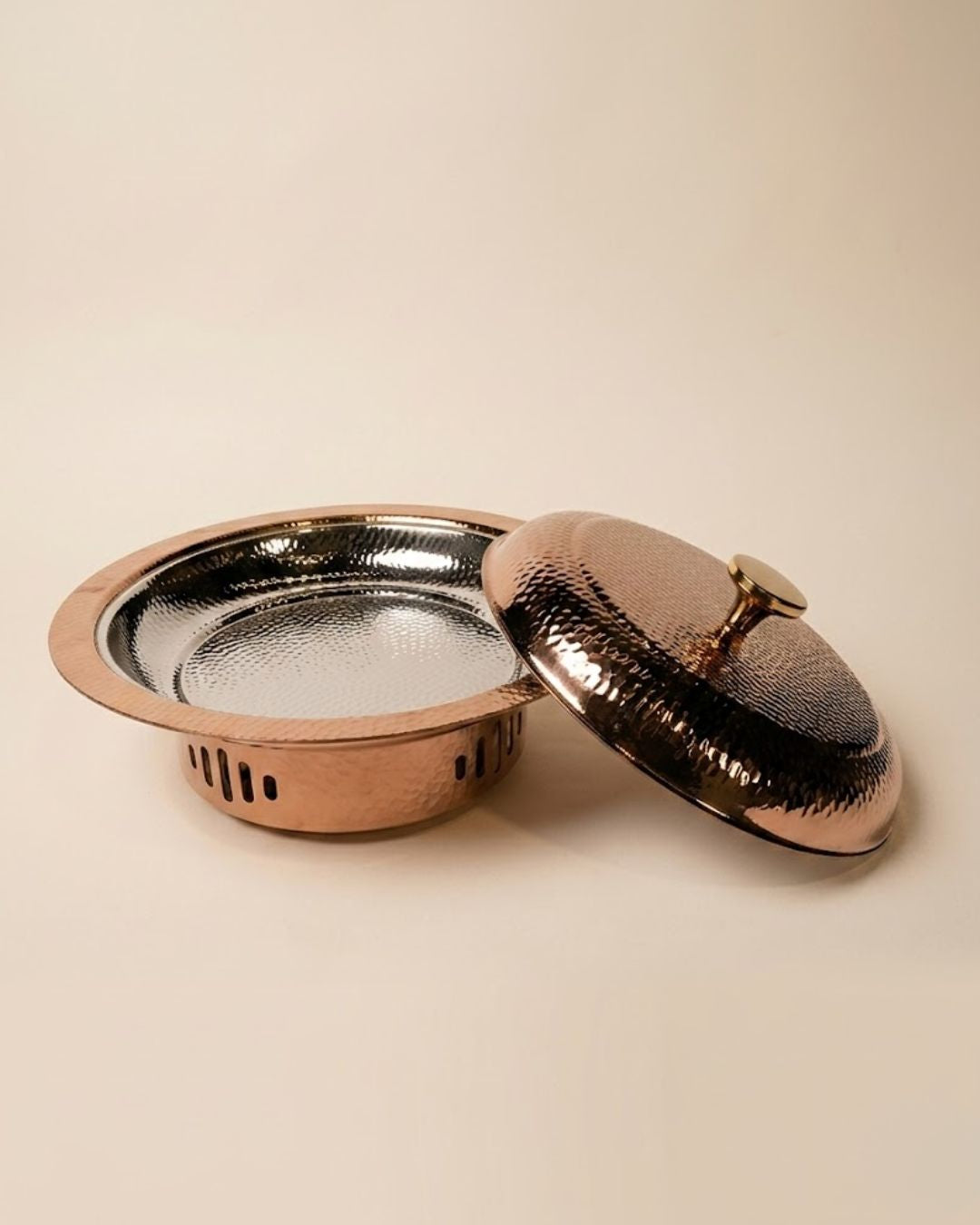 A hammered copper lidded casserole dish with a textured silver interior, shown with its lid resting beside the base on a warm beige background.

Rose Gold Buffet Server with Burner, Triply Stainless Steel Chafing Dish, Hammered Copper Food Warmer Dish, Round Buffet Chafing Server, Luxury Food Warmer for Parties, Stainless Steel Hot Pot Server, Decorative Rose Gold Serving Dish with Lid, Main Course Food Warmer with Fuel Holder, High End Buffet Server USA, Premium Triply Party Chafing Dish