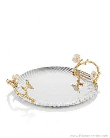 A round silver serving tray with a ribbed edge and ornate gold branch handles decorated with white flowers,  12 Inch Stainless Steel Serving Tray, Luxury Jasmine Tray with Handles, High End Botanical Platter, Metal Serving Platter for Catering, Fluted Silver Cocktail Tray, Premium Catering Food Presentation USA, Designer Vanity Display Dish, Gold and Silver White Flower Tray, Luxury Wedding Cateringware, Decorative Round Metal Platter