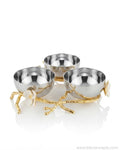 Three small metallic bowls arranged on a decorative gold branch-like base with white flower accents, Stainless Steel Condiment Bowl Set, Luxury 3 Bowl Dip Server, Jasmine Collection Sauce Tray, High End Catering Condiment Platter USA, Silver Trio Serving Dish, Botanical Metal Snack Bowl Stand, Gold and Silver Dip Bowl Set, Designer Cocktail Garnish Tray, Luxury Wedding Tableware, Decorative 3 Tiered Condiment Dish