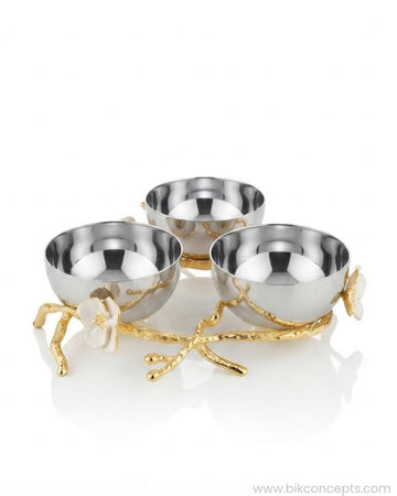 Three small metallic bowls arranged on a decorative gold branch-like base with white flower accents, Stainless Steel Condiment Bowl Set, Luxury 3 Bowl Dip Server, Jasmine Collection Sauce Tray, High End Catering Condiment Platter USA, Silver Trio Serving Dish, Botanical Metal Snack Bowl Stand, Gold and Silver Dip Bowl Set, Designer Cocktail Garnish Tray, Luxury Wedding Tableware, Decorative 3 Tiered Condiment Dish
