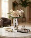 A tall silver vase filled with white and blush peach roses, cream orchids, and green eucalyptus stems, styled on a white marble table in a warm, elegant living room setting, 12 Inch Stainless Steel Vase, Luxury Jasmine Flower Vase, High End Metallic Centerpiece Vase, Botanical Floral Decor Vase for Catering, Modern Silver Tabletop Vase, Premium Event Floral Presentation USA, Designer Metal Console Vessel, Gold and Silver White Flower Vase, Luxury Wedding Centerpiece Vase, Tarnish Resistant Stainless Steel D