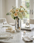 A styled dining table centerpiece featuring a tall silver vase filled with a bouquet of cream and blush peach flowers, set in a bright, modern dining room, 12 Inch Stainless Steel Vase, Luxury Jasmine Flower Vase, High End Metallic Centerpiece Vase, Botanical Floral Decor Vase for Catering, Modern Silver Tabletop Vase, Premium Event Floral Presentation USA, Designer Metal Console Vessel, Gold and Silver White Flower Vase, Luxury Wedding Centerpiece Vase, Tarnish Resistant Stainless Steel Decor