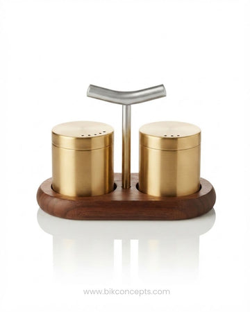A two-shelf salt and pepper grinder set on a white background, featuring cylindrical gold-toned metal shakers with a central silver T-shaped handle, mounted on a dark brown wooden base, Brushed Gold Stainless Steel Seasoning Set, Modern Salt and Pepper Shaker Set with Wood Base, Commercial Hotel Tabletop Seasoning Set, Luxury Catering Salt and Pepper Caddy, Gold Stainless Steel Spice Shaker Set, Tabletop Seasoning Cruet Set with Handle, Decorative Restaurant Salt and Pepper Dispenser, Stainless Steel Condim