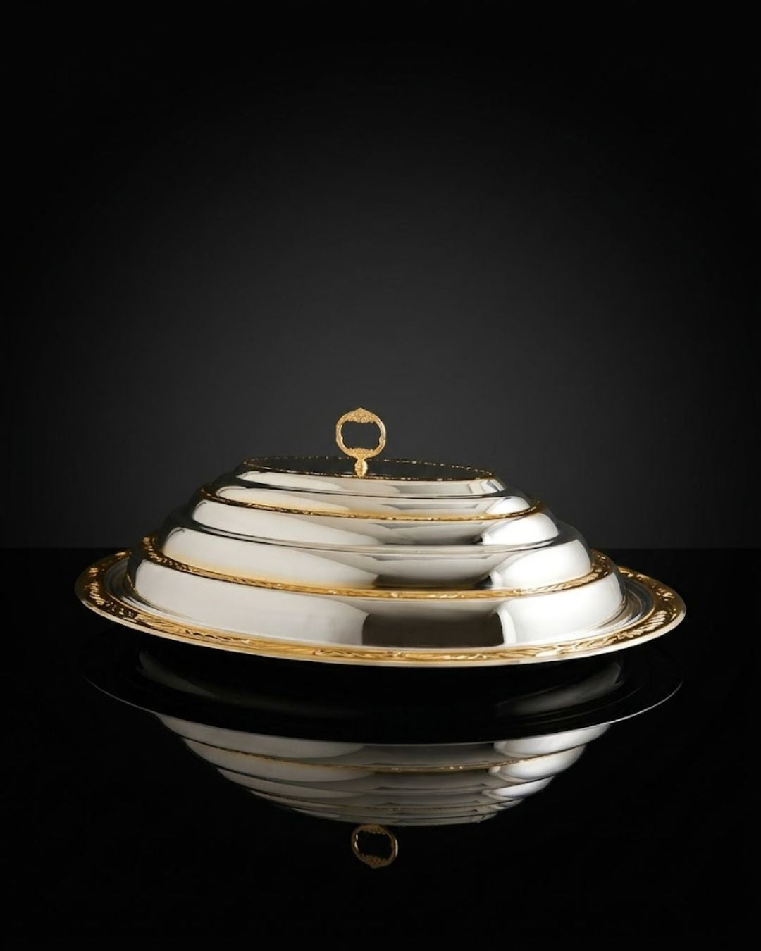 oval serving dish, oval covered serving dish, silver and gold serving dish, two tone serving platter, luxury serving platter, covered serving platter, serving dish with dome lid, oval serving platter with lid, silver gold serving platter, luxury covered platter, decorative serving dish, elegant serving platter, premium serving dish, large oval serving dish, formal dining serving dish, luxury tableware, elegant tableware, statement serving dish, covered food serving dish, dome lid serving platter,