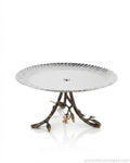 A round pedestal table featuring a silver-toned scalloped metal top and a dark bronze branch-like base with leaf and flower details, Single Tier Stainless Steel Platter, Luxury Pomegranate Cake Stand, High End Pedestal Dessert Server, Botanical Metal Riser for Catering, Fluted Silver Serving Platter, Premium Catering Food Risers USA, 12 Inch Tiered Hors D'oeuvres Display, Luxury Charcuterie Pedestal, Designer Tabletop Servingware, Antique Gold and Silver Cake Riser