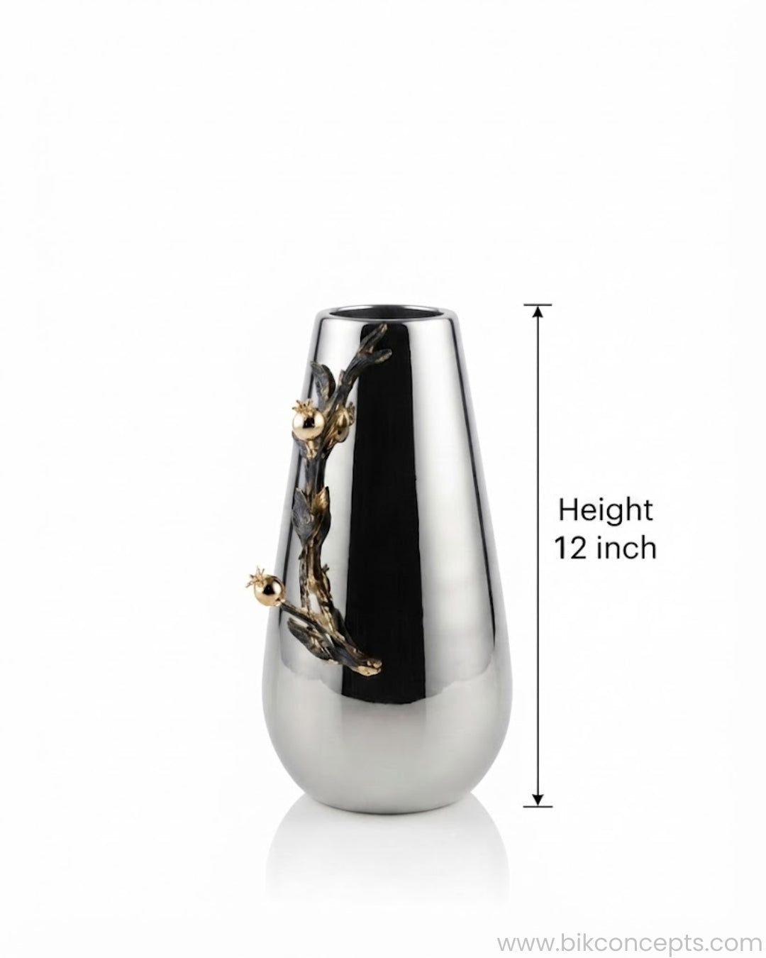 A polished silver-toned vase with a sculptural branch and gold-toned floral detail, shown on a white background with a height measurement marker indicating 12 inches.