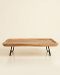 A rectangular wooden serving tray with a natural wood grain top and black metal hairpin legs, Elevated Wood Serving Tray, Raised Wooden Platter with Metal Legs, Wood and Metal Serving Board, Nature Enthusiast Home Decor, Rectangular Wood Table Riser, Solid Hardwood Buffet Platter, Rustic Modern Raised Serving Tray, Black Metal Base Wood Tray, Charcuterie Platter Riser, Biophilic Kitchen Serving Accessories