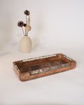 A rectangular wooden serving tray with a dark brown carved center and light brown inlay borders, Wood and Epoxy Resin Serving Tray, Rectangular Solid Wood Serving Tray, Natural Timber Catchall Tray, Nature Enthusiast Home Accessories, Shell Inlaid Resin Platter, Handcrafted Wooden Coffee Tray, Coastal Organic Decor Tray, Slim Rectangular Serving Board, Wooden Vanity Catchall 12x6, Biophilic Home Hosting Decor