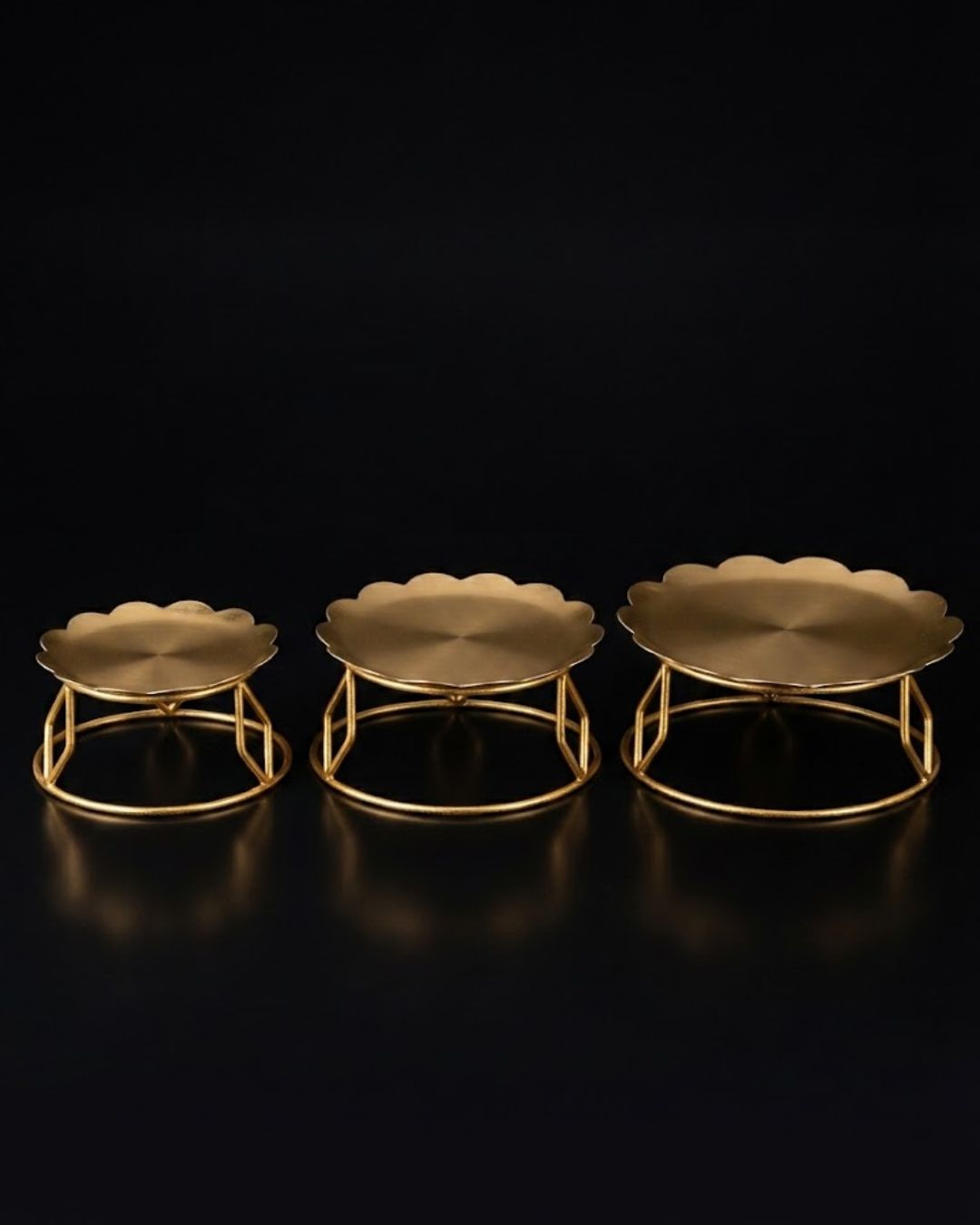 Three gold metal pedestal stands of different heights, Golden Metal Buffet Risers, Round Food Presentation Risers, Floral Scalloped Cake Pedestal, Nature Enthusiast Party Decor, Gold Tiered Dessert Stand, Separable Plate Buffet Display, Botanical Golden Serving Risers, Metal Tabletop Riser Set, Nesting Food Display Pedestals, Elevated Charcuterie Stand Gold