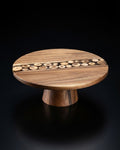 A round wooden pedestal table with a natural wood grain finish and a decorative row of small circular wood inlays across the top, Wood and Epoxy Resin Cake Stand, Round Wooden Cheese Pedestal, Tree Slice Resin Dessert Riser, Nature Enthusiast Bakery Decor, Handmade Wood Charcuterie Stand, Rustic Modern Cake Platter 12 Inch, Resin River Cake Pedestal, Natural Wood Dessert Buffet Display, Elevated Cheese Board Wood Resin, Biophilic Home Kitchen Accessories