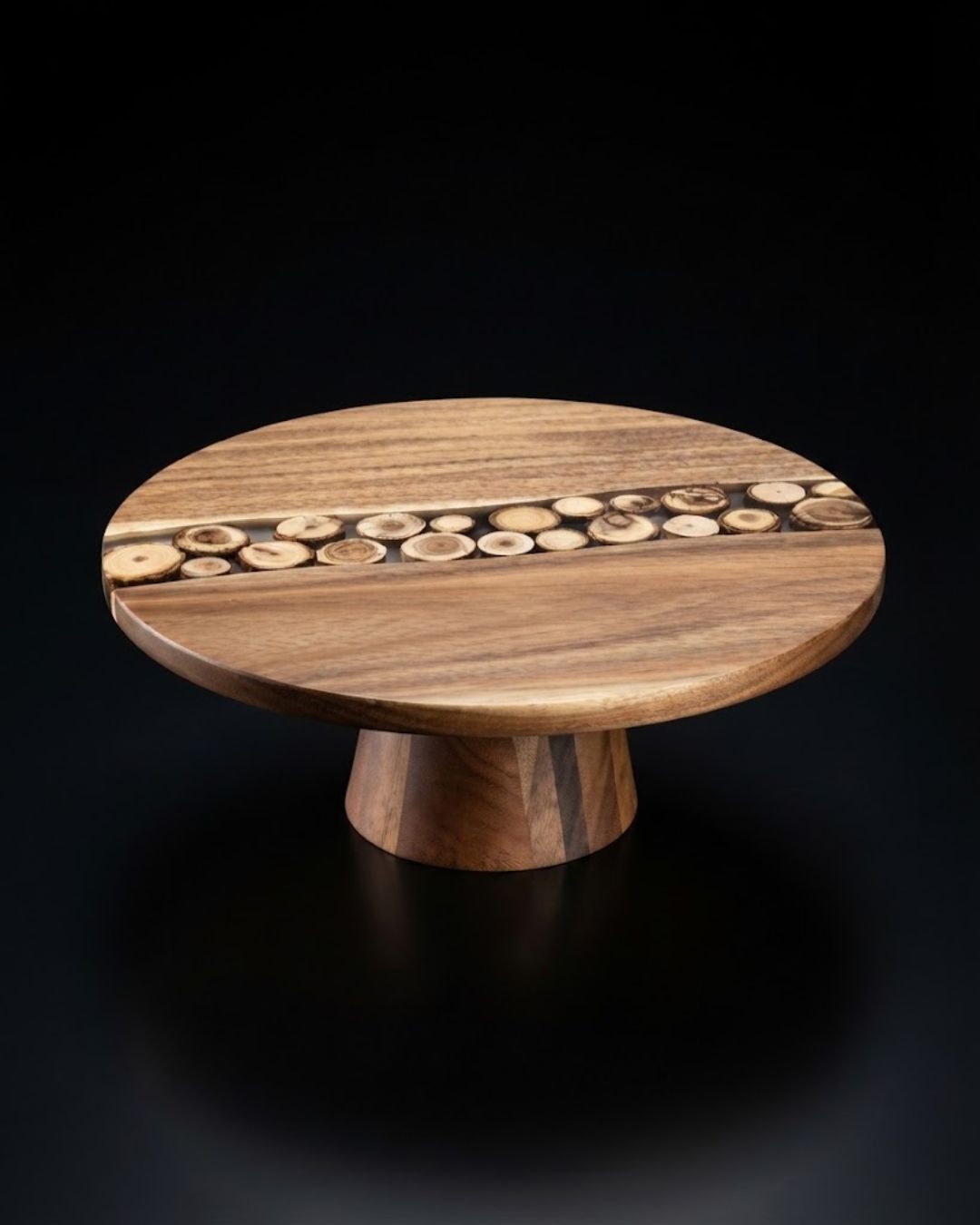 A round wooden pedestal table with a natural wood grain finish and a decorative row of small circular wood inlays across the top, Wood and Epoxy Resin Cake Stand, Round Wooden Cheese Pedestal, Tree Slice Resin Dessert Riser, Nature Enthusiast Bakery Decor, Handmade Wood Charcuterie Stand, Rustic Modern Cake Platter 12 Inch, Resin River Cake Pedestal, Natural Wood Dessert Buffet Display, Elevated Cheese Board Wood Resin, Biophilic Home Kitchen Accessories