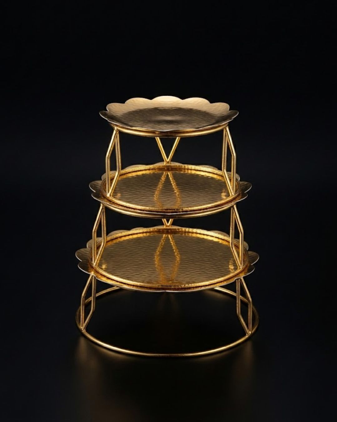A three-tiered gold metal serving stand with scalloped edges on each tray, Golden Metal Buffet Risers, Round Food Presentation Risers, Floral Scalloped Cake Pedestal, Nature Enthusiast Party Decor, Gold Tiered Dessert Stand, Separable Plate Buffet Display, Botanical Golden Serving Risers, Metal Tabletop Riser Set, Nesting Food Display Pedestals, Elevated Charcuterie Stand Gold