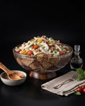 A large ribbed glass salad bowl filled with a mixed salad, set on a dark studio background with a small side dish, wooden spoon, napkin with fork, and a glass oil bottle, Wood and Epoxy Resin Serving Bowl, Round Wooden Mosaic Serving Bowl, Fluted Resin Fruit Bowl, Nature Enthusiast Home Decor, Footed Resin Timber Bowl, Geometric Wood Mosaic Pedestal Bowl, Organic Modern Kitchen Basin, Handcrafted Wooden Centerpiece Bowl, Artisanal Ribbed Glass Look Bowl, Biophilic Home Accessories