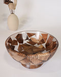 A large wooden bowl with a geometric mosaic pattern of interlocking triangular wood pieces, Wood and Epoxy Resin Serving Bowl, Round Wooden Mosaic Serving Bowl, Fluted Resin Fruit Bowl, Nature Enthusiast Home Decor, Footed Resin Timber Bowl, Geometric Wood Mosaic Pedestal Bowl, Organic Modern Kitchen Basin, Handcrafted Wooden Centerpiece Bowl, Artisanal Ribbed Glass Look Bowl, Biophilic Home Accessories