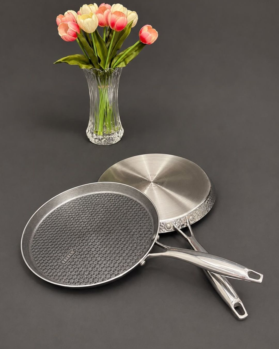 Two stainless steel frying pans with textured and smooth interiors, Honeycomb Stainless Steel Pizza Pan, Hammered Silver Tawa Pan, Luxury Stainless Steel Flat Skillet, High End Non Stick Crepe Pan USA, Designer Roti Naan Tawa, Professional Grade Pizza Steel Pan, Decorative Hammered Stainless Cookware, Induction Compatible Tawa Skillet, Estate Kitchenware Gourmet Cookware, Large Diameter Flat Cooking Pan