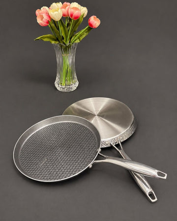 Two stainless steel frying pans with textured and smooth interiors, Honeycomb Stainless Steel Pizza Pan, Hammered Silver Tawa Pan, Luxury Stainless Steel Flat Skillet, High End Non Stick Crepe Pan USA, Designer Roti Naan Tawa, Professional Grade Pizza Steel Pan, Decorative Hammered Stainless Cookware, Induction Compatible Tawa Skillet, Estate Kitchenware Gourmet Cookware, Large Diameter Flat Cooking Pan