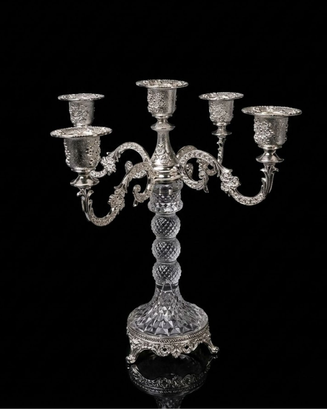 An ornate silver candelabra with five candle cups, featuring a faceted crystal-like stem and decorative scrollwork, set against a solid black background.
Silver 5 Candle Stand, 5 Arm Candelabra Centerpiece, Glass and Metal Candle Holder, Wedding Table Candelabra Wholesale, VIP Dinner Party Candle Stand, High End Catering Table Centerpiece, Taper Candle Candelabra Silver, Vintage Silver Table Candle Holder, 11 Inch Candelabra Centerpiece, Luxury Event Decor Candle Stand