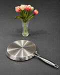 A stainless steel frying pan with a hammered textured rim and a long handle, Honeycomb Stainless Steel Pizza Pan, Hammered Silver Tawa Pan, Luxury Stainless Steel Flat Skillet, High End Non Stick Crepe Pan USA, Designer Roti Naan Tawa, Professional Grade Pizza Steel Pan, Decorative Hammered Stainless Cookware, Induction Compatible Tawa Skillet, Estate Kitchenware Gourmet Cookware, Large Diameter Flat Cooking Pan
