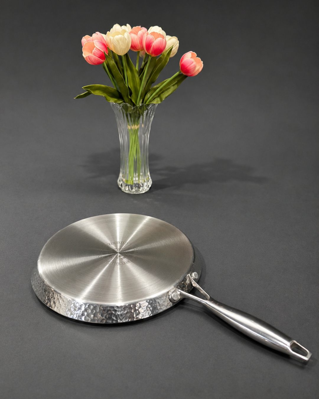 A stainless steel frying pan with a hammered textured rim and a long handle, Honeycomb Stainless Steel Pizza Pan, Hammered Silver Tawa Pan, Luxury Stainless Steel Flat Skillet, High End Non Stick Crepe Pan USA, Designer Roti Naan Tawa, Professional Grade Pizza Steel Pan, Decorative Hammered Stainless Cookware, Induction Compatible Tawa Skillet, Estate Kitchenware Gourmet Cookware, Large Diameter Flat Cooking Pan