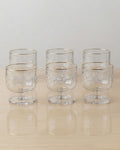 Six clear glass goblets with a textured pattern and gold rim, arranged in two rows on a light wooden surface against a neutral off-white background,

Textured Glass Dessert Bowls, 5.5 oz Ice Cream Cups Set of 6, Footed Sundae Dishes, Gold Rim Parfait Glasses, Hammered Glass Dessert Cups, Mini Trifle Dishes for Catering, Commercial Catering Glassware USA, Clear Footed Sorbet Cups, Vintage Style Ripple Sundae Glass, Heavy Duty Mini Dessert Glasses